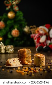 Sliced Christmas Panettone With Spread Dry Fruits On A Wooden Table. Christmas Decoration.