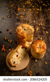 Sliced Christmas Panettone With Spread Dry Fruits On A Wooden Table. Christmas Decoration. Top View.