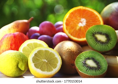 sliced citric fruits, kiwi and grapes