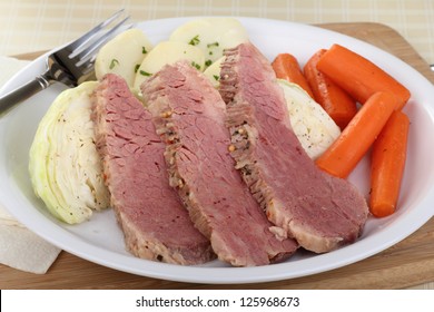 Sliced Corned Beef With Cabbage, Carrots And Potatoes On A Plate