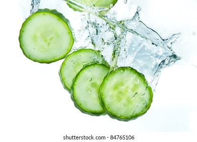 Sliced Cucumber Splashing Water Isolated On White Background