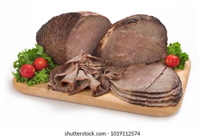 Sliced Deli Roast Beef On Cutting Board, Garnished With Lettuce And Cherry Tomatoes, Isolated On White Background