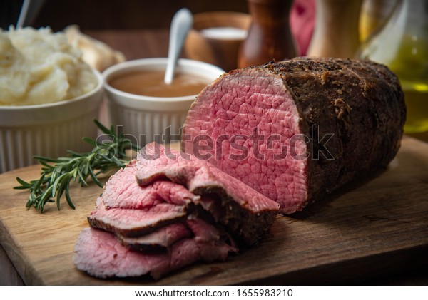 sliced\
eye of round beef roasted beef on cutting\
board