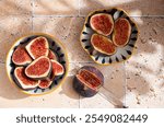 Sliced figs in a porcelain plate on the table. Top view