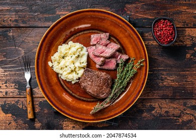 Sliced Fillet Mignon Or Tenderloin Beef Steak On A Rustic Plate With Mashed Potato. Dark Wooden Background. Top View