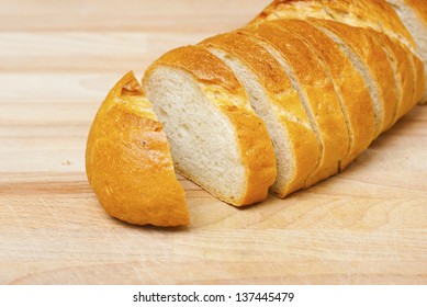Sliced French Bread On Wood Cutting Board
