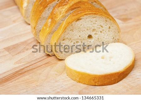 sliced french bread on wood cutting board