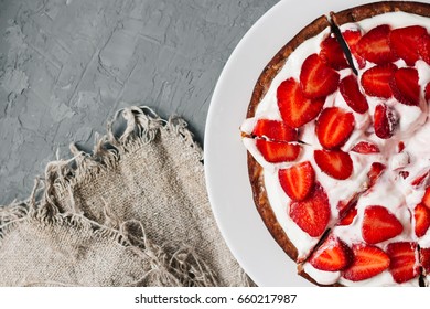 Sliced Fresh Baked Homemade Pie With Strawberries And Whipped Cream And Cinnamon On Rustic Background. Close-up. Top Or Overhead View. Thanksgiving Desserts Or Cake Sweet Pastry. Copy Space.