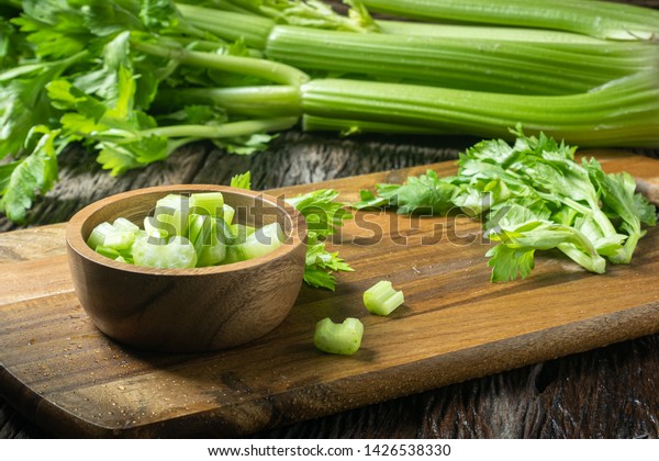 Sliced fresh celery or Celery stalk on cutting\
wooden board