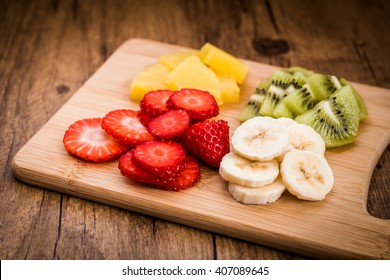 Sliced fruit on a cutting board. Ingredients for fruit salad - Powered by Shutterstock