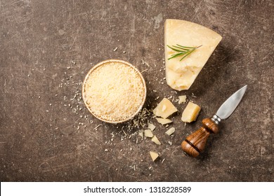 Sliced and grated parmesan cheese on stone table - Shutterstock ID 1318228589