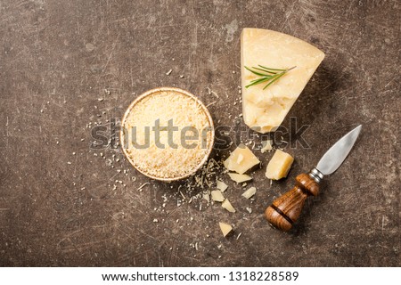 Sliced and grated parmesan cheese on stone table