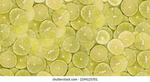 Sliced Green Limes Stacked On Top Of Each Other In Piles.