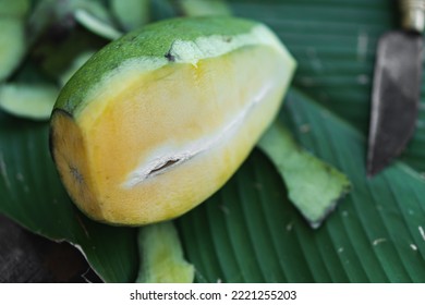 Sliced Green Mango Isolated On Banana Leaf Background