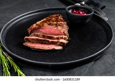 Sliced Grilled Filet Mignon Steak. Beef Tenderloin. Black Background. Top View