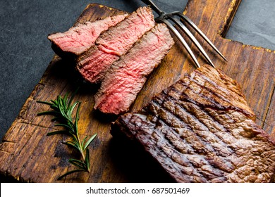 Sliced Grilled Medium Rare Beef Steak Served On Wooden Board Barbecue, Bbq Meat Beef Tenderloin. Top View, Slate Background.