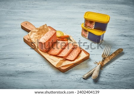 Sliced ​​grilled ham is plated on a wooden cutting board covered with parchment paper
