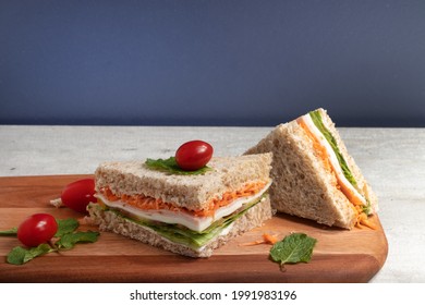 Sliced healthy sandwich of integral bread stuffed with carrots, letucce, mozzarella and ham - Shutterstock ID 1991983196