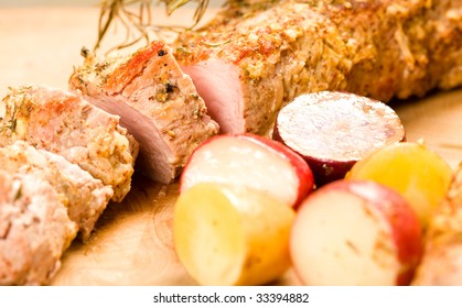 Sliced Herb Encrusted Pork Tenderloin With Whole Rosemary, Sage, And Roasted Potatoes