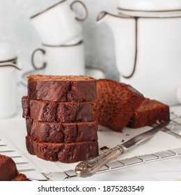 Sliced homemade chocolate pound cake loaf. Delicious dessert. A treat for tea or coffee. Breakfast on a marble table against a gray concrete wall. Selective focus, square picture - Shutterstock ID 1875283549