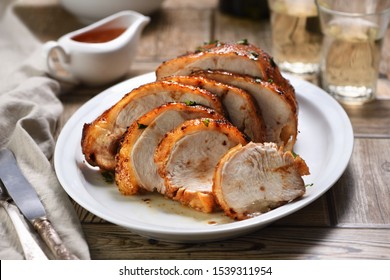 Sliced Into Slices Baked Turkey Breast Close-up At The Dinner Table