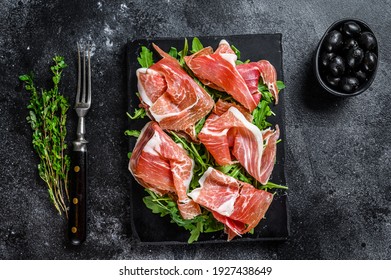 Sliced Jamon Serrano Pork Ham Meat On A Marble Board. Black Background. Top View.