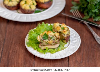 Sliced Large Brown Stuffed Mushroom With Mashed Potato Filling. Vegan Mushrooms Caps With Mashed Potatoes Filling, Portion On A Plate. Wooden Background, Close Up, Selective Focus.