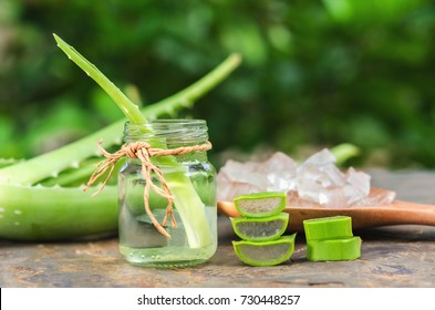 sliced and leaf of fresh aloe vera with  essential oil in glass and gel product on spoon