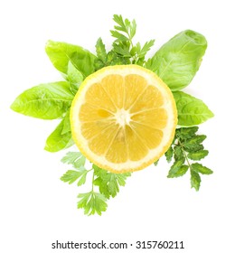 Sliced Lemon And Green Herbs On A White Background