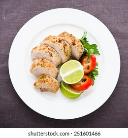 Sliced Lime Pork Tenderloin On Dark Canvas Background Top View.