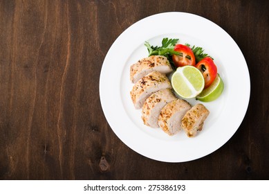 Sliced Lime Pork Tenderloin On Dark Wooden Background Top View. Space For Text. Healthy Food.