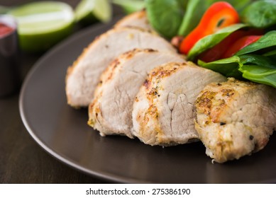 Sliced Lime Pork Tenderloin With Vegetables Salad On Dark Wooden Background Close Up.  Healthy Food.