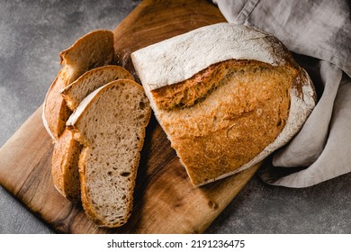 Sliced loaf of bread on cutting board. Top view. - Shutterstock ID 2191236475