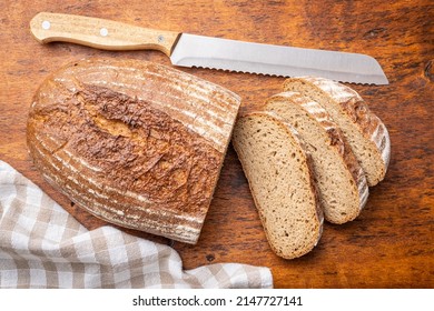 Sliced Loaf Of Bread On Wooden Table. Top View.