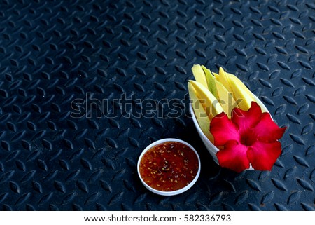 sliced mango, spicy sauce with iron background, popular fruit for Asia woman and pregnant woman