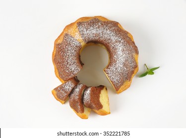 Sliced Marble Bundt Cake On White Background