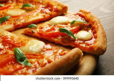 Sliced Margherita Pizza On Wooden Background, Close Up