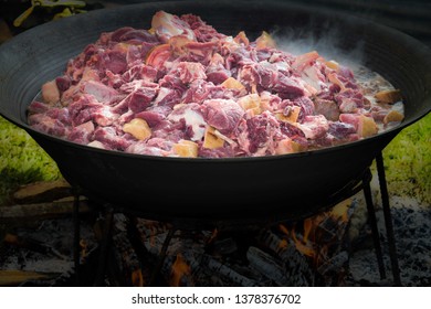 Sliced Meat Cooked On A Very Large Pot For A Very Big Crowd