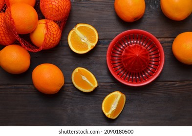 Sliced Orange Fruits And Hand Juicer On Wooden Table