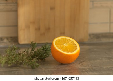 Sliced Orange On A Wooden Table. Juniper Sprig