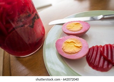 Sliced organic pickled beet eggs on wooden table