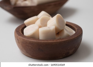 Sliced palm heart in a bowl on a white background