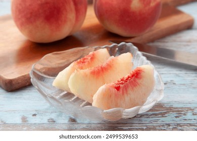 Sliced ​​white peaches served on a glass plate - Powered by Shutterstock