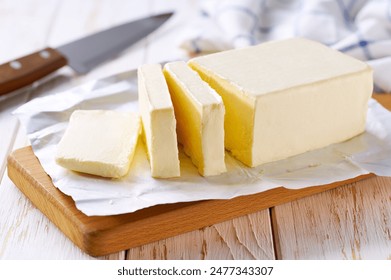 Sliced pieces of butter on a light table, selective focus. Piece of butter.