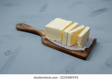 Sliced pieces of butter on a light table, selective focus. Piece of butter.