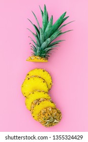 Sliced Pieces Of Delicious Pineapple On Color Paper Pink Background. Tropical Summer Fruits Flatlay, Food Concept