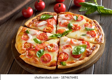 Sliced pizza Margherita on wooden table - Powered by Shutterstock