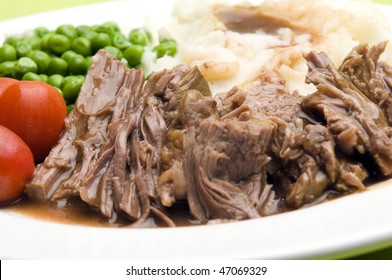 Sliced Pot Roast Beef Dinner With Peas Mashed Potatoes And Gravy