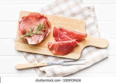 Sliced Prosciutto Crudo On Cutting Board.