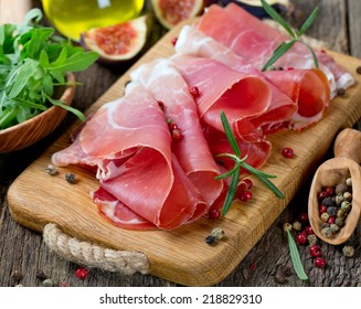 Sliced Prosciutto On A Wooden Board